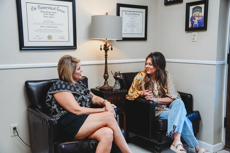 Two patients talking at seating area