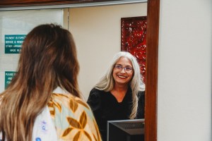 Patient being helped at front desk