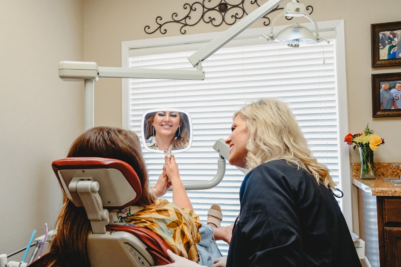 Doctor showing patient smile with a mirror