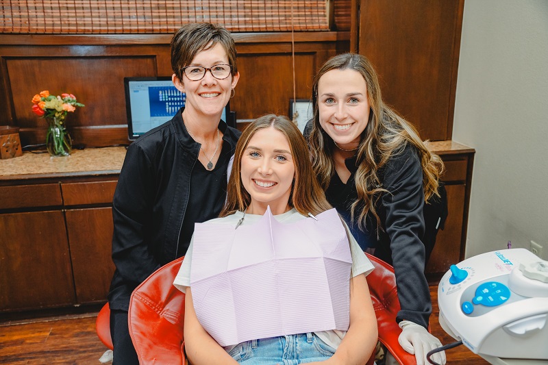 Patient smiling for photo in chair