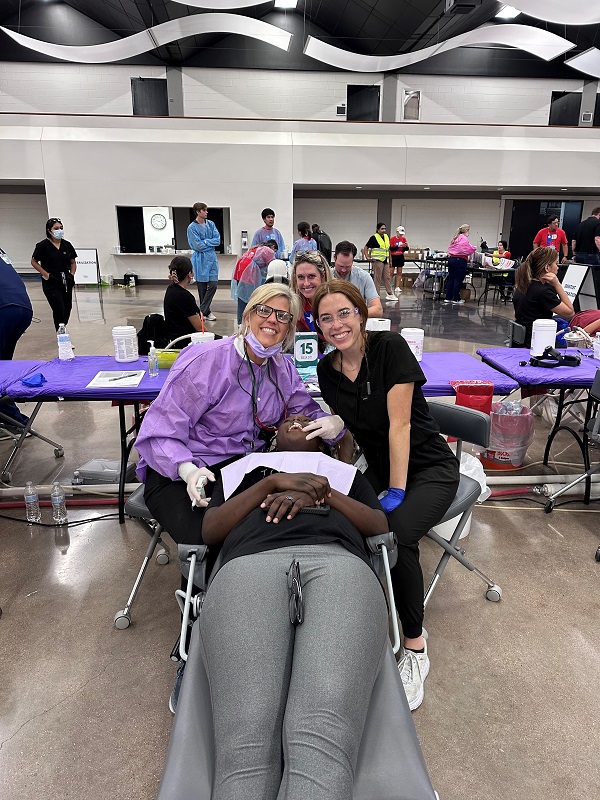 Posing with patient at giving back event